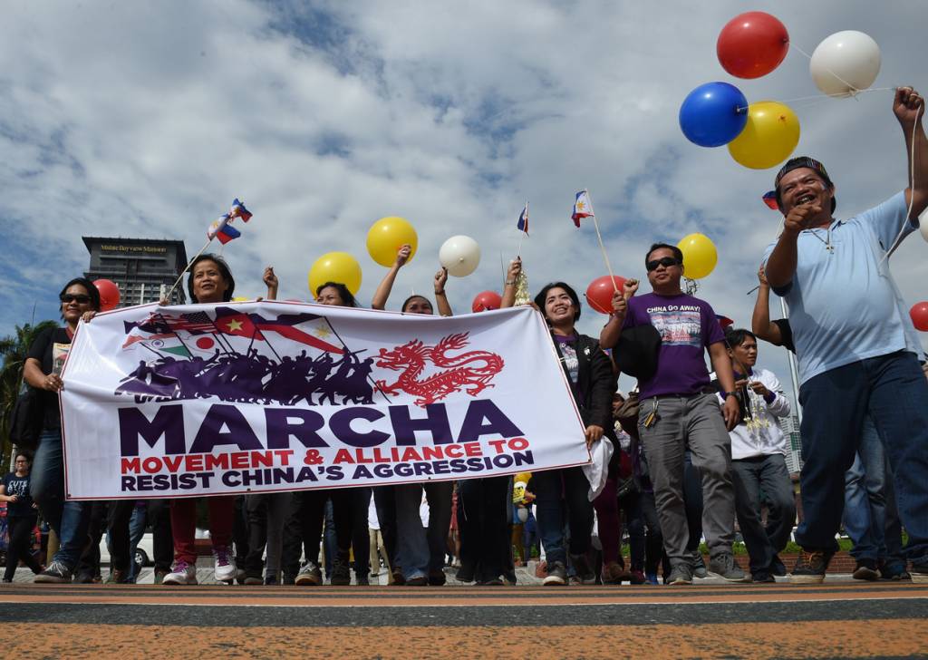 Filipino activists and Vietnamese nationals march as they anticipate a favourable decision from a UN tribunal ruling on the legality of China's claims to an area of the South China sea contested by the Philippines, during a demonstration along the bay walk in Roxas Boulevard in Manila on July 12, 2016. The Philippines welcomes a ruling by a UN-backed tribunal on Tuesday that declares China has no "historic rights" in the South China Sea, Foreign Secretary Perfecto Yasay said, as he urged restraint. / AFP / TED ALJIBE (Photo credit should read TED ALJIBE/AFP/Getty Images)