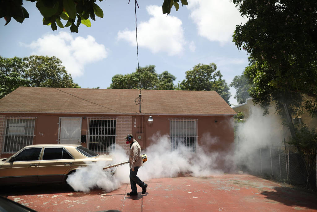 MIAMI, FL - AUGUST 02: Carlos Varas, a Miami-Dade County mosquito control inspector, uses a Golden Eagle blower to spray pesticide to kill mosquitos in the Wynwood neighborhood as the county fights to control the Zika virus outbreak on August 2, 2016 in Miami, Florida. There is a reported 14 individuals who have been infected with the Zika virus by local mosquitoes. (Photo by Joe Raedle/Getty Images)