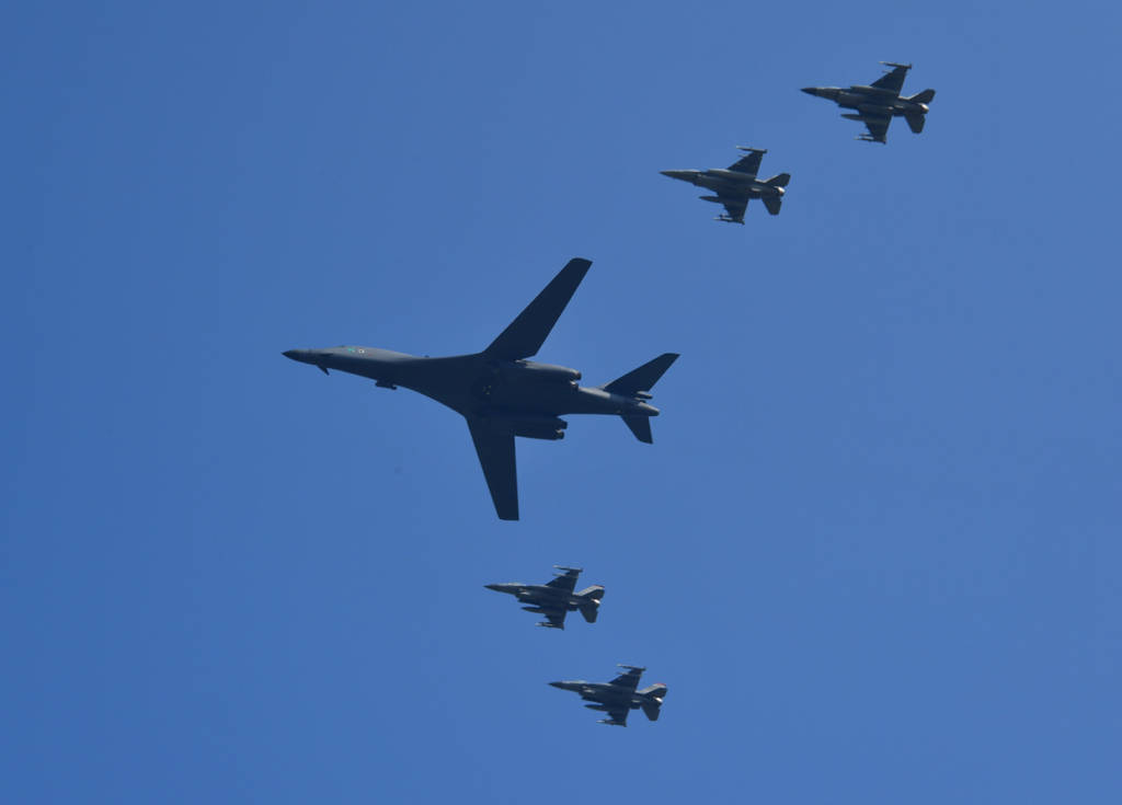 A US B-1B Lancer (C) is escorted by US F-16 fighter jets as it flies over the Osan Air Base, aiming at reinforcing the US commitment to its key ally in Pyeongtaek on September 13, 2016. / AFP / JUNG YEON-JE (Photo credit should read JUNG YEON-JE/AFP/Getty Images)