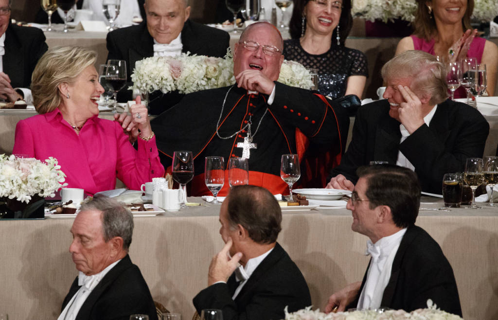 Republican presidential candidate Donald Trump, right, Cardinal Timothy Dolan, Archbishop of New York, center, and Democratic presidential candidate Hillary Clinton share a laugh during the Alfred E. Smith Memorial Foundation dinner, Thursday, Oct. 20, 2016, in New York. (AP Photo/ Evan Vucci)