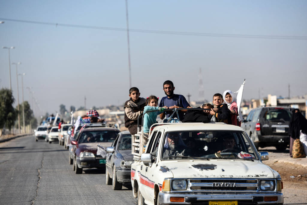 An Iraqi family, who fled the violence due to the ongoing operation by Iraqi forces against jihadists of the Islamic State group to retake the city of Mosul, drives on November 3, 2016 as they leave Gogjali, which lies on the eastern edge of Mosul, before heading to camps housing displaced people. Some civilians were leaving Gogjali and others the eastern Mosul neighbourhood of Samah, in what may be a rare breach for civilians trapped inside the city. More than 21,000 people have fled to government-held areas since October 17, while thousands more may have been seized by IS for use as human shields, according to the United Nations. / AFP / BULENT KILIC (Photo credit should read BULENT KILIC/AFP/Getty Images)