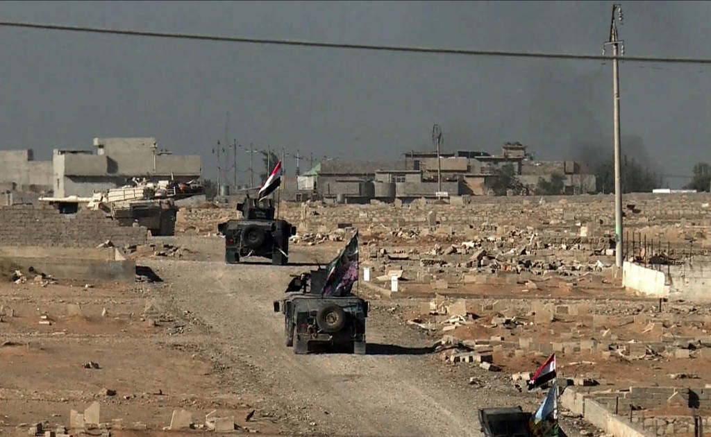 An image grab taken from AFPTV shows an Iraqi forces M1 Abrams tank leading a convoy of armoured vehicles as they enter the Al-Karamah district of eastern Mosul on November 4, 2016, during a military operation to retake the main hub city from the Islamic State (IS) group jihadists. Jihadist fighters unleashed a deluge of bombs and gunfire on Iraqi forces punching into the streets of Mosul for the first time, forcing some units into a partial pullback. / AFP / AFPTV / Andrea BERNARDI (Photo credit should read ANDREA BERNARDI/AFP/Getty Images)