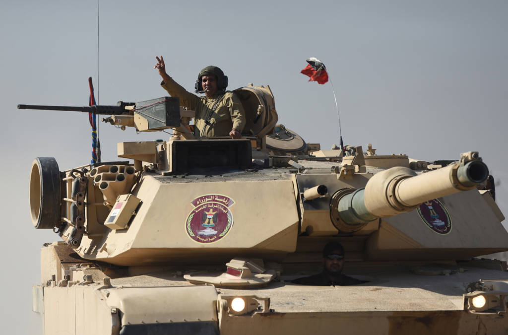An Iraqi army M1 Abrams tank drives through Gogjali as it heads to Mosul, on November 4, 2016, during a military operation to retake the main hub city from the Islamic State (IS) group jihadists. Jihadist fighters unleashed a deluge of bombs and gunfire on Iraqi forces punching into the streets of Mosul for the first time, forcing some units into a partial pullback. / AFP / BULENT KILIC / ALTERNATIVE CROP (Photo credit should read BULENT KILIC/AFP/Getty Images)
