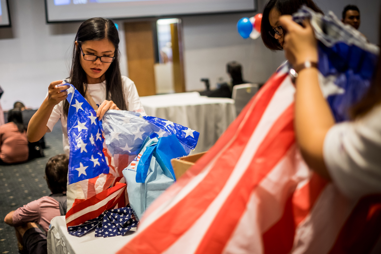 HO CHI MINH CITY, VIETNAM - NOVEMBER 09: Staffs clean up the U.S. flag tape as the live election results watch party hosted by the United States Consulate General goes to an end at a convention center on November 9, 2016 in Ho Chi Minh City, Vietnam. Donald Trump's stunning performance in the US presidential election triggered shock and angst in Asia, where observers fretted over the implications for everything from trade to human rights and climate change. (Photo by Linh Pham/Getty Images)