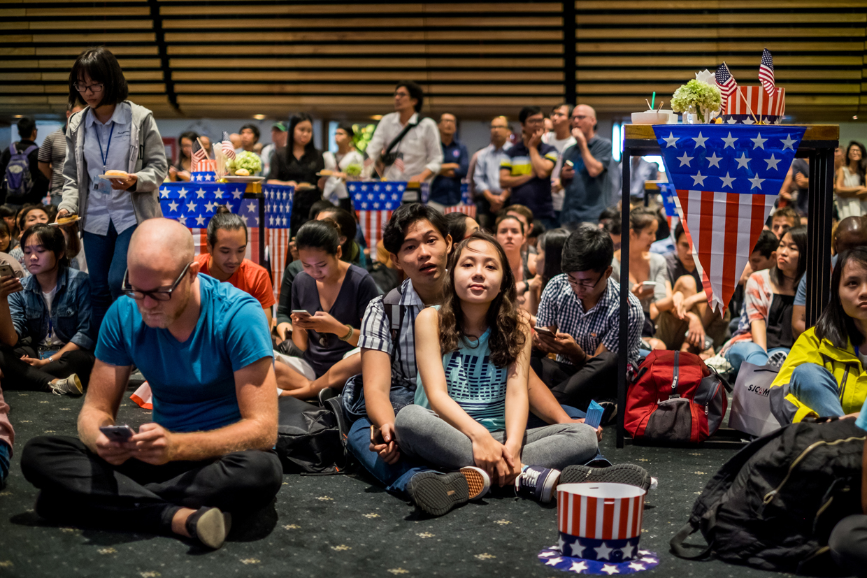 HO CHI MINH CITY, VIETNAM - NOVEMBER 09: People watch live election results hosted by the United States Consulate General at a convention center on November 9, 2016 in Ho Chi Minh City, Vietnam. Donald Trump's stunning performance in the US presidential election triggered shock and angst in Asia, where observers fretted over the implications for everything from trade to human rights and climate change. (Photo by Linh Pham/Getty Images)