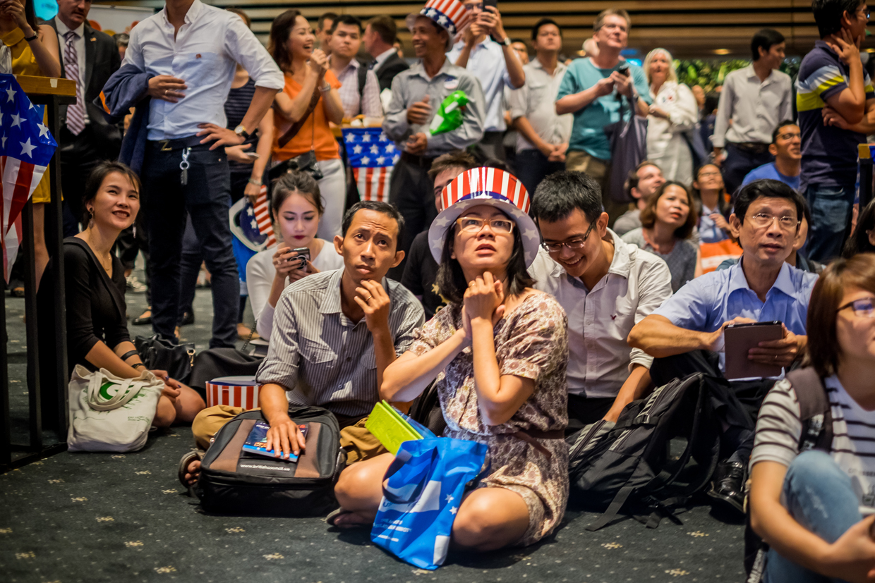 HO CHI MINH CITY, VIETNAM - NOVEMBER 09: People watch live election results hosted by the United States Consulate General at a convention center on November 9, 2016 in Ho Chi Minh City, Vietnam. Donald Trump's stunning performance in the US presidential election triggered shock and angst in Asia, where observers fretted over the implications for everything from trade to human rights and climate change. (Photo by Linh Pham/Getty Images)