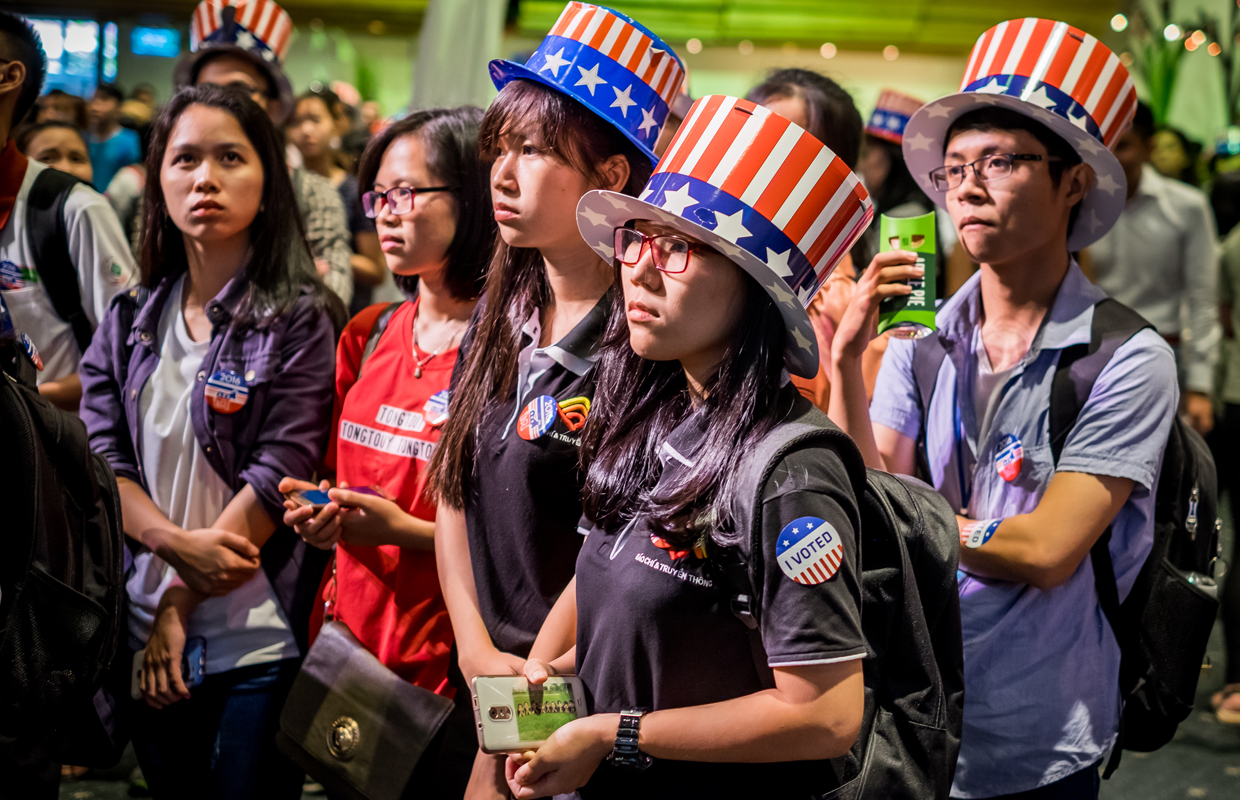 HO CHI MINH CITY, VIETNAM - NOVEMBER 09: People watch live election results hosted by the United States Consulate General at a convention center on November 9, 2016 in Ho Chi Minh City, Vietnam. Donald Trump's stunning performance in the US presidential election triggered shock and angst in Asia, where observers fretted over the implications for everything from trade to human rights and climate change. (Photo by Linh Pham/Getty Images)