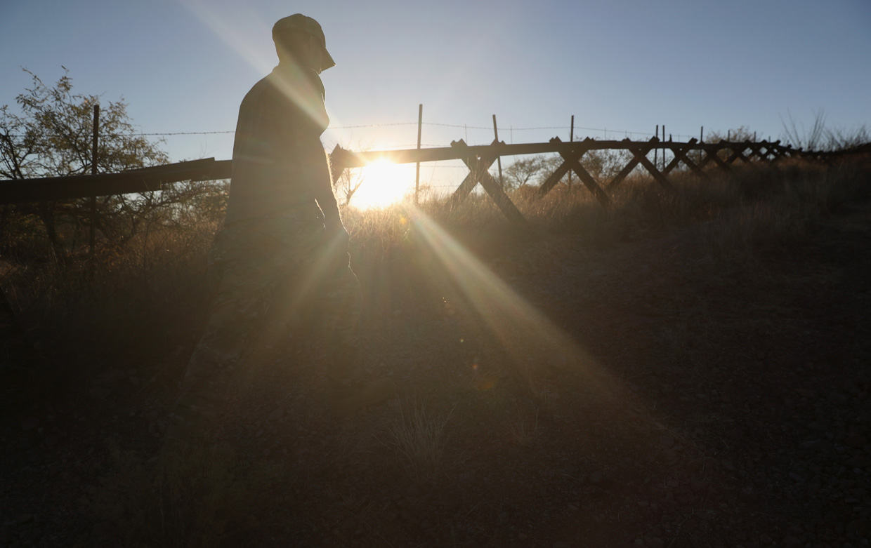 ARIVACA, AZ - NOVEMBER 14: Arizona Border Recon director Tim Foley walks next to the U.S.-Mexico border fence on November 14, 2016 near Arivaca, Arizona. The armed group, made up mostly of former U.S. military servicemen and women, stages reconnaissance and surveillance operations against drug and human smuggling operations in remote border areas. The group, with up to 200 volunteers, does not consider itself a militia, but rather a group of citizens supplementing U.S. Border Patrol efforts to control illegal border activity. With the election of Donald Trump as President, border security issues are a top issue for the incoming Administration. (Photo by John Moore/Getty Images)