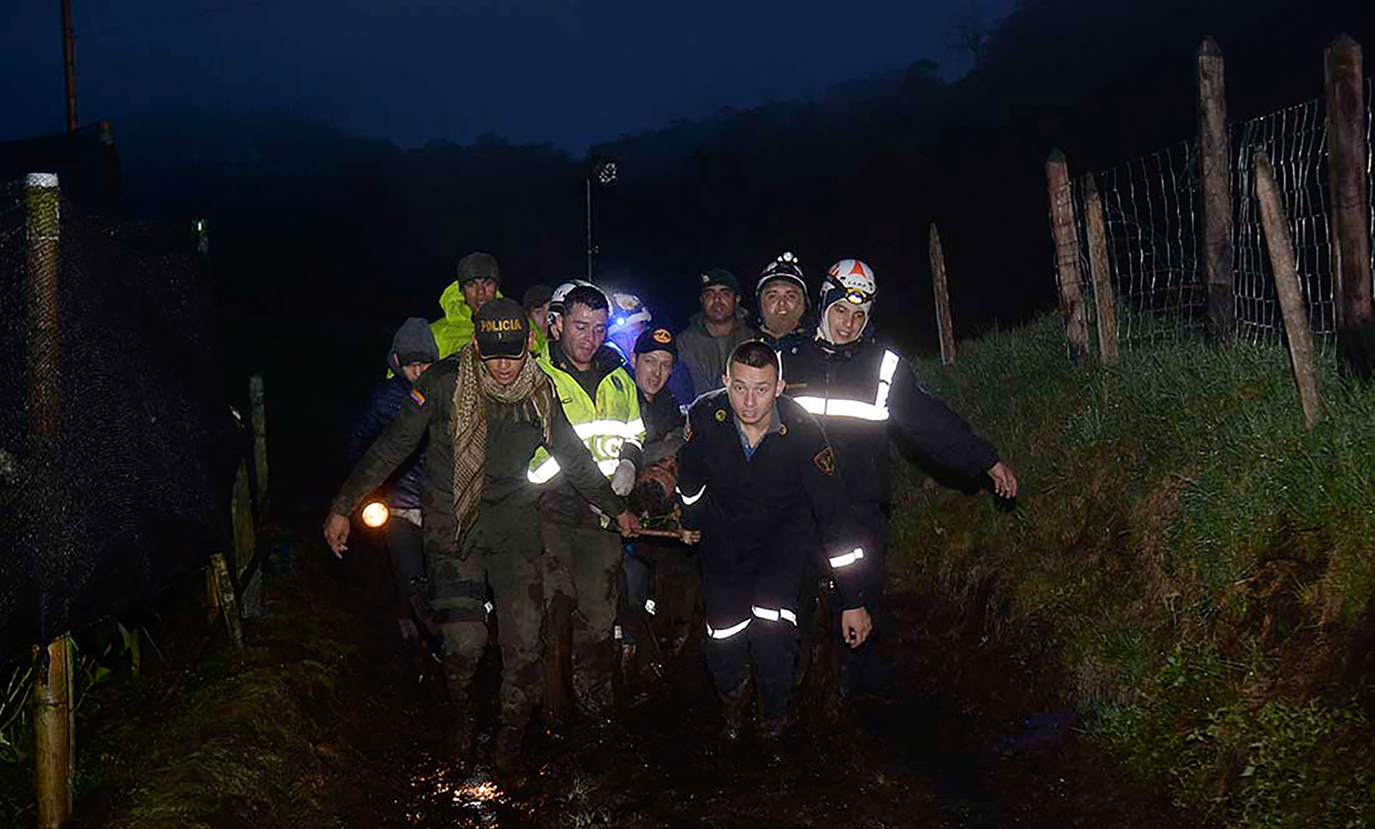 Rescuers carry one of the survivors from the LAMIA airlines charter plane carrying members of the Chapecoense Real football team that crashed in the mountains of Cerro Gordo, municipality of La Union, on November 29, 2016. A charter plane carrying the Chapocoense Real football team crashed in the mountains in Colombia late Monday, killing as many as 75 people, officials said. / AFP / Raul ARBOLEDA (Photo credit should read RAUL ARBOLEDA/AFP/Getty Images)