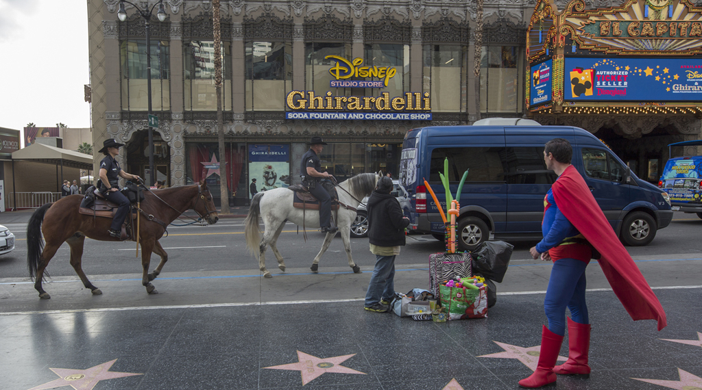 LOS ANGELES, CA - DECEMBER 06: Los Angeles Police Department Mounted Platoon officers ride down Hollywood Boulevard as police and deputies step up security near the Hollywood/Highland Red Line Metro train station and other stops on December 6, 2016 in Los Angeles, California. An increase in security is in response to Federal and Los Angeles officials who say they were alerted by authorities in another country that an imminent and very specific threat has been made against the city's Red Line commuter rail system. (Photo by David McNew/Getty Images)