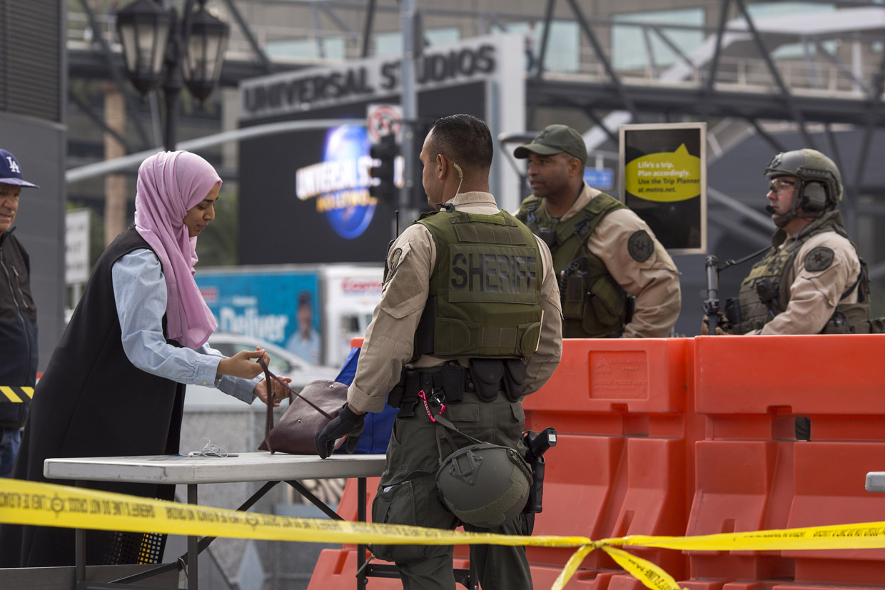 LOS ANGELES, CA - DECEMBER 06: A woman's belongings are searched as Los Angeles County Sheriff's deputies stand guard over rail passengers at the Universal City Red Line Metro train station on December 6, 2016 in Los Angeles, California. An increase in security is in response to Federal and Los Angeles officials who say they were alerted by authorities in another country that an imminent and very specific threat has been made against the city's Red Line commuter rail system. The credibility has not yet been verified. (Photo by David McNew/Getty Images)
