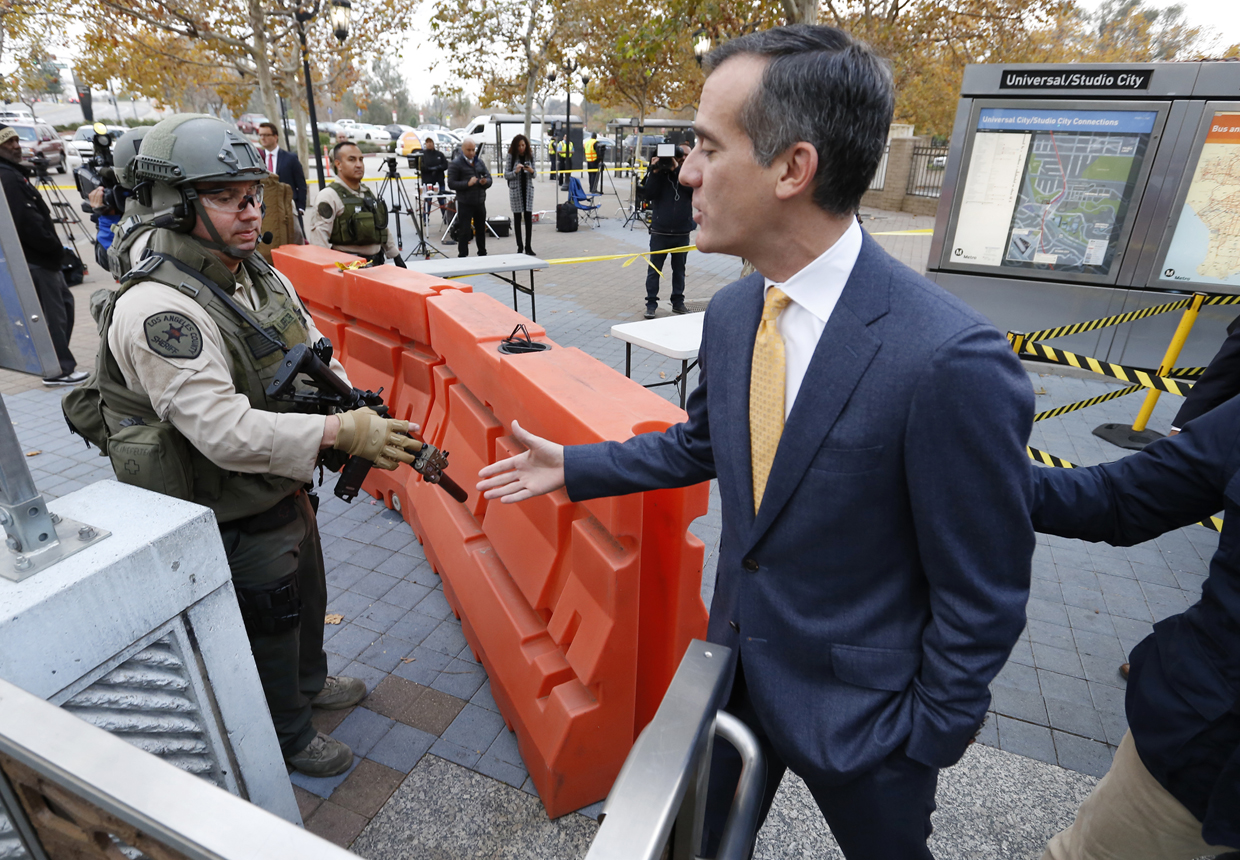 LOS ANGELES, CA - DECEMBER 6: Los Angeles Mayor Eric Garcetti shakes hands with Los Angeles County Sheriff Deputy's as he prepares to board the Metro Red Line at the Universal City / Studio City Station on Tuesday morning December 6, 2016 in Los Angeles, California. Garcetti rode the metro in response to a warning about a bomb plot against Universal City station. An overseas tip about an imminent bombing of the Metro Red Line's Universal City station has forced federal and local law enforcement in Los Angeles to swiftly ramp up security across its sprawling transit system, authorities said Monday. An anonymous man warned of a potential attack on Tuesday and provided the information on a tip line abroad, according to Deidre Fike, the assistant director in charge of the FBI's office in Los Angeles. (Photo by Al Seib - Pool/Getty Images)