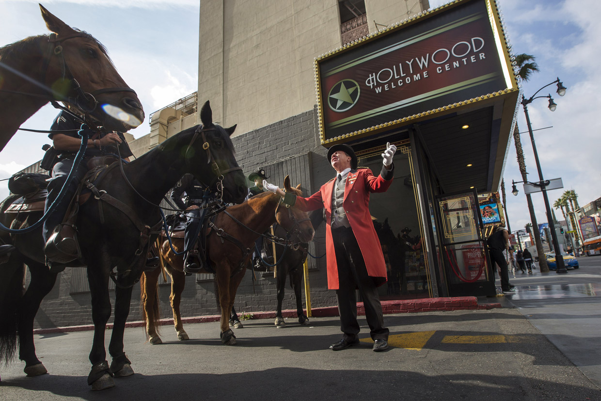 LOS ANGELES, CA - DECEMBER 06: Greg Donovan, self-described unofficial ambassador to Hollywood, talks to Los Angeles Police Department Mounted Platoon officers on Hollywood Boulevard as police and deputies step up security near the Hollywood/Highland Red Line Metro train station and other stops on December 6, 2016 in Los Angeles, California. An increase in security is in response to Federal and Los Angeles officials who say they were alerted by authorities in another country that an imminent and very specific threat has been made against the city's Red Line commuter rail system. (Photo by David McNew/Getty Images)