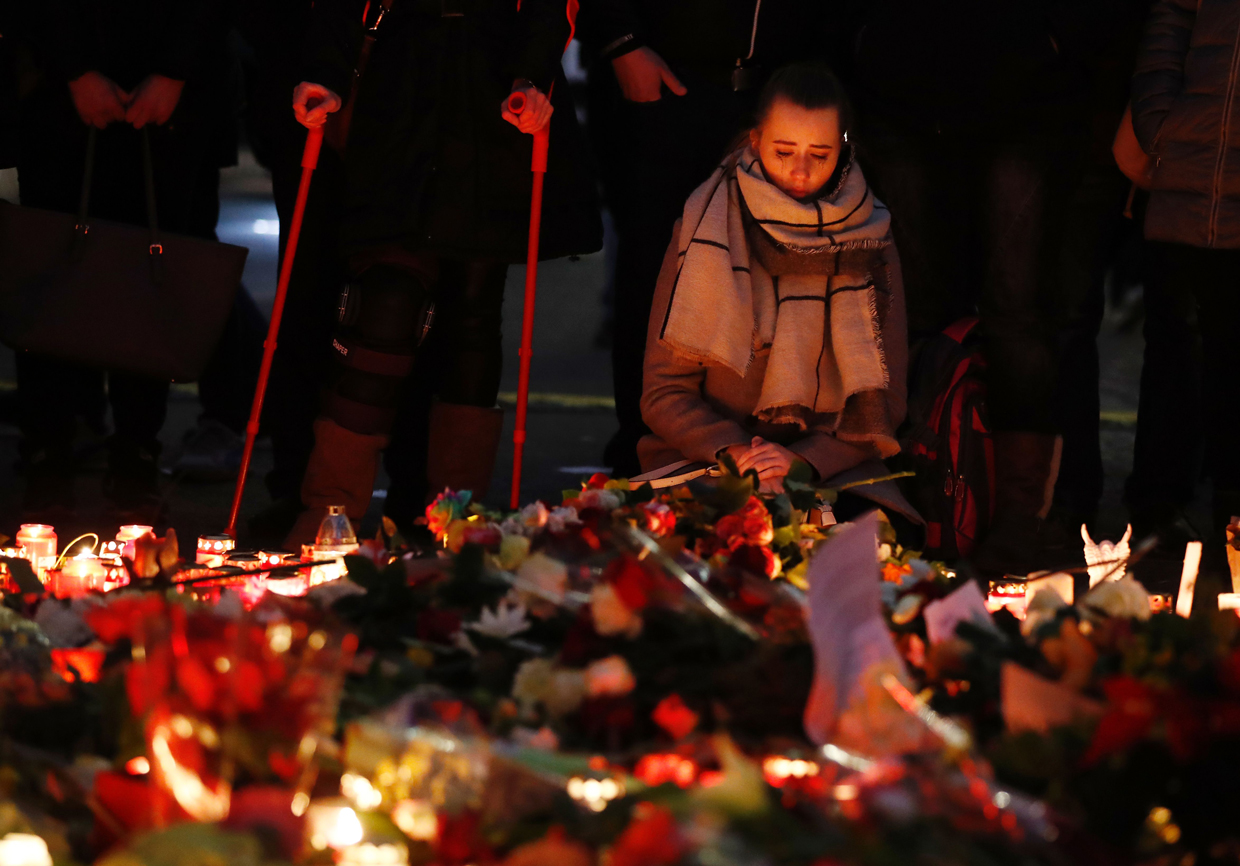 TOPSHOT - A woman mourns on December 20, 2016 at a makeshift memorial in front of the Kaiser-Wilhelm-Gedaechtniskirche (Kaiser Wilhelm Memorial Church) in Berlin, where a truck crashed the day before into a Christmas market. Twelve people were killed and almost 50 wounded, 18 seriously, when the lorry tore through the crowd on December 19, 2016, smashing wooden stalls and crushing victims, in scenes reminiscent of July's deadly attack in the French Riviera city of Nice. / AFP / Odd ANDERSEN (Photo credit should read ODD ANDERSEN/AFP/Getty Images)