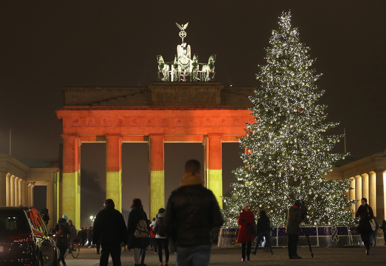 BERLIN, GERMANY - DECEMBER 20: The Brandenburg Gate stands illuminated in the colors of the German flag the day after a truck drove into a crowded Christmas market in the city center on December 20, 2016 in Berlin, Germany. So far 12 people are confirmed dead and 45 injured. Authorities have confirmed they believe the incident was an attack and have arrested a Pakistani man who they believe was the driver of the truck and who had fled immediately after the attack. Among the dead are a Polish man who was found on the passenger seat of the truck. Police are investigating the possibility that the truck, which belongs to a Polish trucking company, was stolen yesterday morning. (Photo by Sean Gallup/Getty Images)