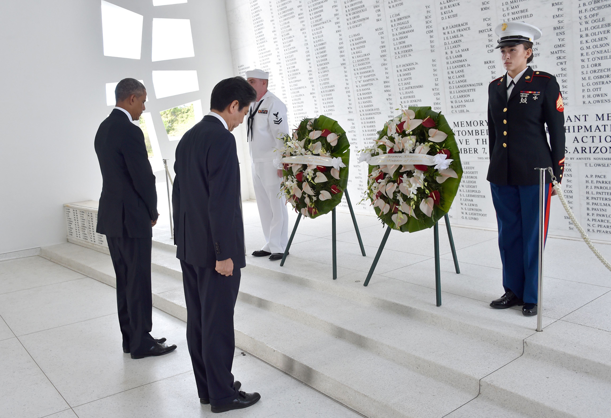 US President Barack Obama(L) and Japanese Prime Minister Shinzo Abe place wreaths at the USS Arizona Memorial December 27, 2016 at Pearl Harbor in Honolulu, Hawaii. Abe and Obama made a joint pilgrimage to the site of the Pearl Harbor attack on Tuesday to celebrate "the power of reconciliation. "The Japanese attack on an unsuspecting US fleet moored at Pearl Harbor turned the Pacific into a cauldron of conflict -- more than 2,400 were killed and a reluctant America was drawn into World War II. / AFP / Nicholas Kamm (Photo credit should read NICHOLAS KAMM/AFP/Getty Images)