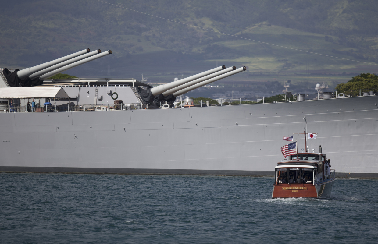 HONOLULU, HI - DECEMBER 27: A boat carrying US President Barack Obama and Japanese Prime Minister Shinzo Abe goes by the USS Missouri at Joint Base Pearl Harbor Hickam on December 27, 2016 in Honolulu, Hawaii. Mr. Abe will be the first Japanese prime minister to visit Pearl Harbor with a U.S. president and the first to visit the USS Arizona Memorial. (Photo by Kent Nishimura/Getty Images)