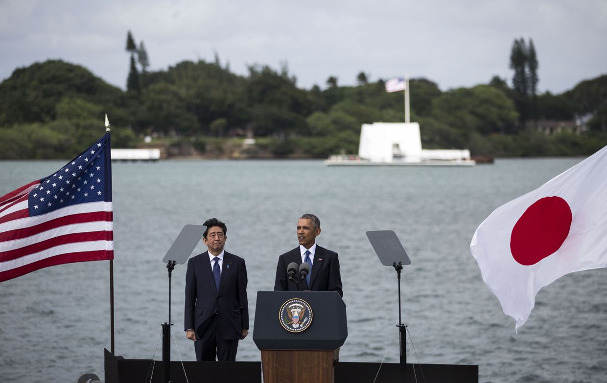 HONOLULU, HI - DECEMBER 27: U.S. President Barack Obama delivers remarks while Japanese Prime Minister Shinzo Abe listens at Joint Base Pearl Harbor Hickam's Kilo Pier on December 27, 2016 in Honolulu, Hawaii. Abe is the first Japanese prime minister to visit Pearl Harbor with a U.S. president and the first to visit the USS Arizona Memorial. (Photo by Kent Nishimura/Getty Images)