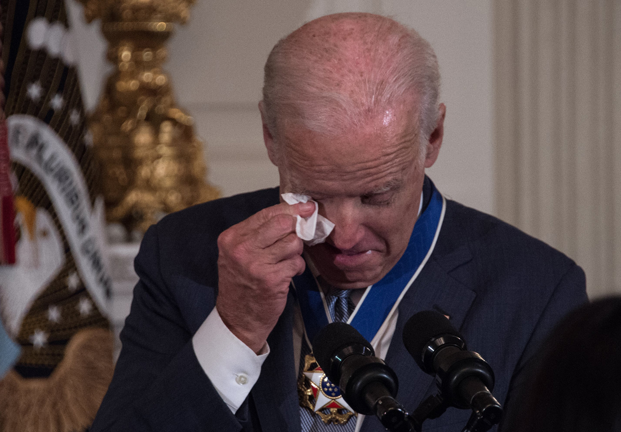 US Vice President Joe Biden wipes away tears after President Barack Obama awarded him the Presidential Medal of Freedom during a tribute to Biden at the White House in Washington, DC, on January 12, 2017. / AFP / NICHOLAS KAMM (Photo credit should read NICHOLAS KAMM/AFP/Getty Images)
