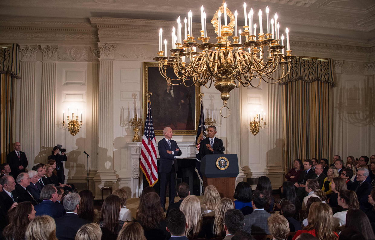 US Vice President Joe Biden (center L) listens to President Barack Obama speak during a tribute to Biden at the White House in Washington, DC, on January 12, 2017. / AFP / NICHOLAS KAMM (Photo credit should read NICHOLAS KAMM/AFP/Getty Images)