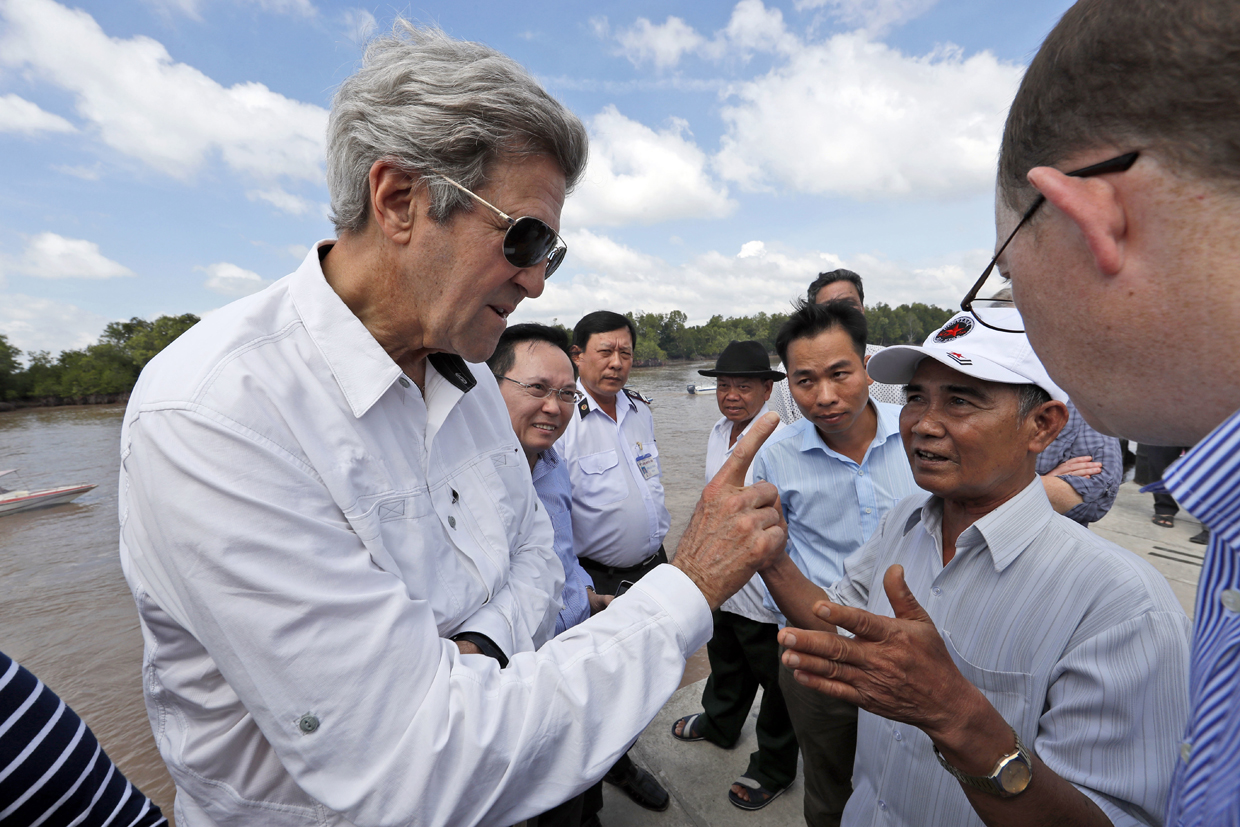 CORRECTION - US Secretary of State John Kerry (L) talks with Vo Ban Tam, 70, who was a member of the former Viet Cong and who took part in the attack on Kerry's Swift Boat on February 28, 1969, while on a tour of the region, in the Mekong River Delta on January 14, 2017. Kerry is in Vietnam, his fourth and final trip to the communist nation where he served during the war. / AFP / POOL / Alex Brandon / The erroneous mention[s] appearing in the metadata of this POOL photo by Alex Brandon has been modified in AFP systems in the following manner: [Vo Ban Tam instead of [Vo Van Tam]. Please immediately remove the erroneous mention[s] from all your online services and delete it (them) from your servers. If you have been authorized by AFP to distribute it (them) to third parties, please ensure that the same actions are carried out by them. Failure to promptly comply with these instructions will entail liability on your part for any continued or post notification usage. Therefore we thank you very much for all your attention and prompt action. We are sorry for the inconvenience this notification may cause and remain at your disposal for any further information you may require. (Photo credit should read ALEX BRANDON/AFP/Getty Images)