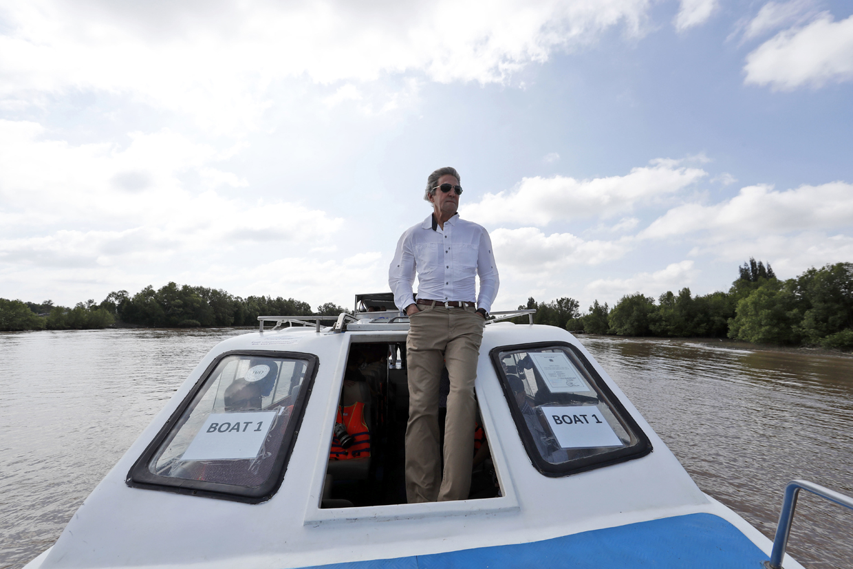 US Secretary of State John Kerry rides a boat in the Mekong River Delta on January 14, 2017. Kerry is in Vietnam, his fourth and final trip to the communist nation where he served during the war. / AFP / POOL / Alex Brandon (Photo credit should read ALEX BRANDON/AFP/Getty Images)