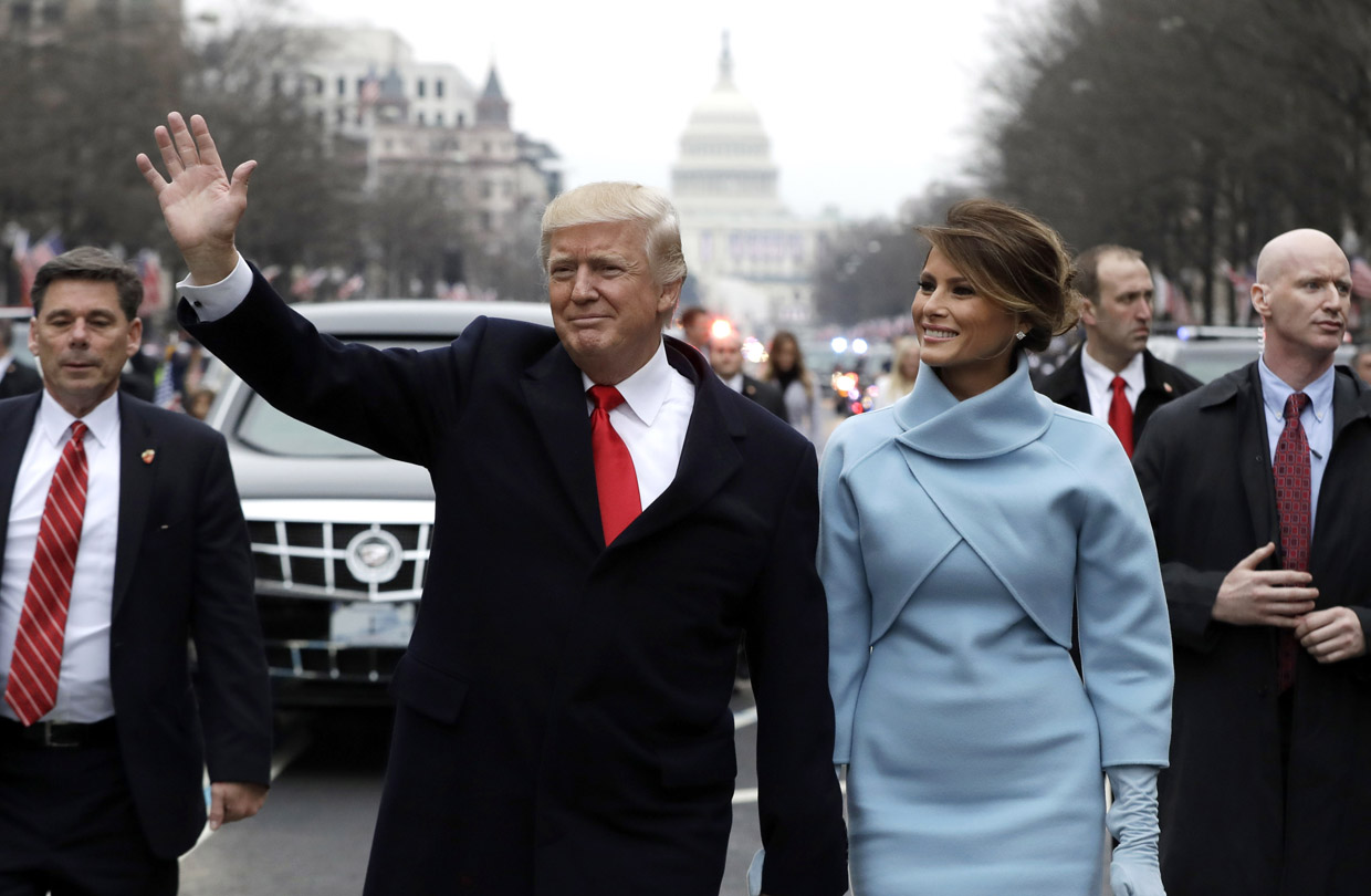 WASHINGTON, DC - JANUARY 20: U.S. President Donald Trump waves to supporters as he walks the parade route with first lady Melania Trump after being sworn in at the 58th Presidential Inauguration January 20, 2017 in Washington, D.C. Donald J. Trump was sworn in today as the 45th president of the United States (Photo by Evan Vucci - Pool/Getty Images)