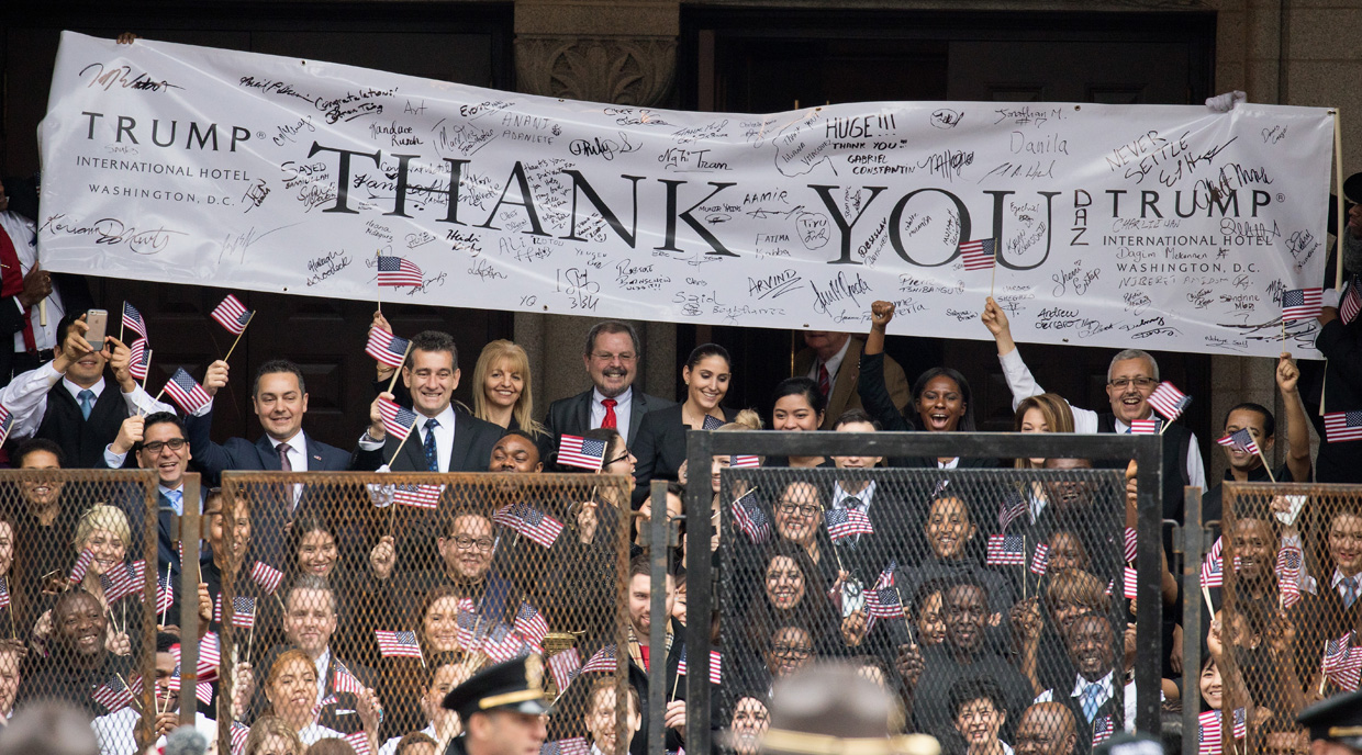 WASHINGTON, DC - JANUARY 20: Trump International Hotel employees cheer during the Inaugural Parade on January 20, 2017 in Washington, DC. Donald J. Trump was sworn in today as the 45th president of the United States. (Photo by Tasos Katopodis/Getty Images)