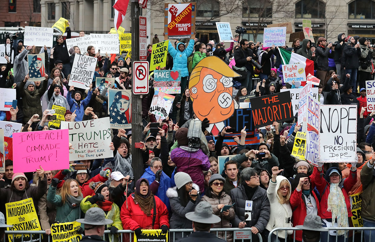 WASHINGTON, DC - JANUARY 20: Protesters of U.S. President Donald J. Trump line the Inaugural Parade at the U.S. Naval Memorial on Pennsylvania Avenue January 20, 2017 in Washington, DC. Trump was sworn in today as the 45th president of the United States. (Photo by Chip Somodevilla/Getty Images)