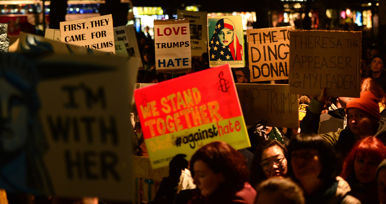 EDINBURGH, SCOTLAND - JANUARY 30: Placards are held aloft as crowds listen to a speaker at the Mound as demonstrators march to the Scottish Parliament to protest against President Trump's Muslim travel ban to the USA on January 30, 2017 in Edinburgh, Scotland. President Trump signed an executive order on Friday banning immigration to the USA from seven muslim countries. This led to protests across America and, today, in the UK a British petition asking for the downgrading of Trump's State visit passed one million signatures this morning. (Photo by Mark Runnacles/Getty Images)