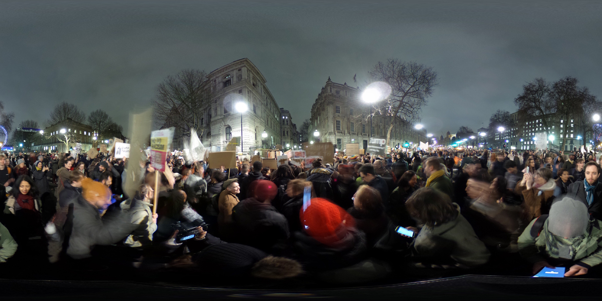 LONDON, ENGLAND - JANUARY 30: (EDITOR'S NOTE: Image was created as an Equirectangular Panorama. Import image into a panoramic player to create an interactive 360 degree view.) Demonstrators hold up placards during a protest outside Downing Street against U.S. President Donald Trump's ban on travel from seven Muslim countries on January 30, 2017 in London, England. President Trump signed an executive order on Friday banning immigration to the USA from seven Muslim countries. This led to protests across America and, today, the UK. A British petition asking for the downgrading of Trump's State visit passed one million signatures this morning. (Photo by Ming Yeung/Getty Images)