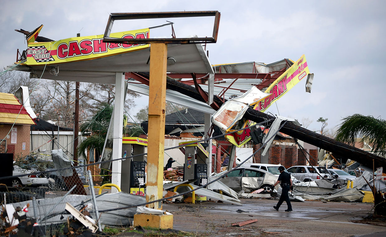 NEW ORLEANS, LA - FEBRUARY 07: A police officer walks through a damaged gas station along Chef Menture Avenue after a tornado touched down in the eastern part of the city on February 7, 2017 in New Orleans, Louisiana. According to the weather service, 25 people were injured in the aftermath of the tornado. (Photo by Sean Gardner/Getty Images)