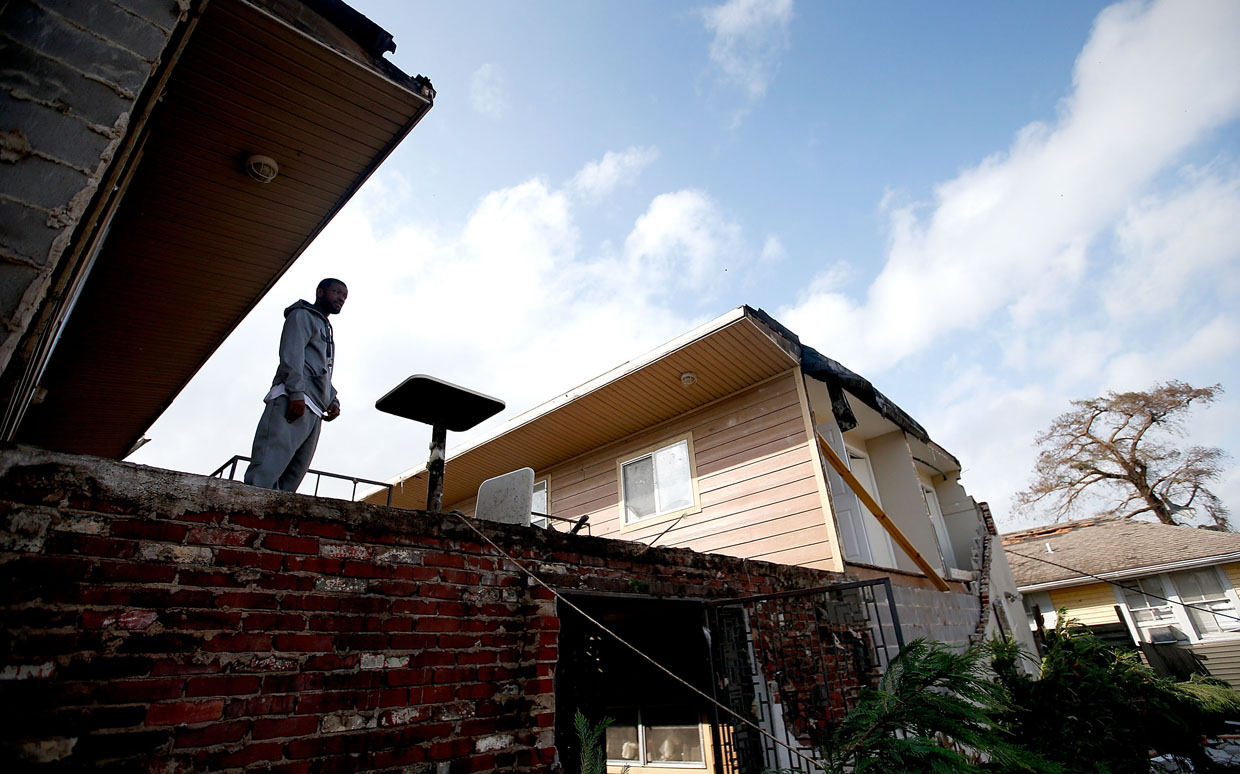 NEW ORLEANS, LA - FEBRUARY 07: A man looks out from his apartment balcony after tornado ripped off his roof and destroyed his car on February 7, 2017 in New Orleans, Louisiana. According to the weather service, 25 people were injured in the aftermath of the tornado. (Photo by Sean Gardner/Getty Images)
