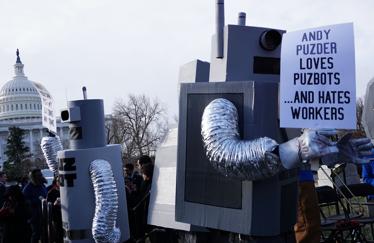 Labor activists demonstrate on February 16, 2017, after Andrew Puzder withdrew from his nomination as US Labor Secretary. Puzder withdrew on February 15 from consideration after facing intense scrutiny for his business record and controversies about his personal past. / AFP / MANDEL NGAN (Photo credit should read MANDEL NGAN/AFP/Getty Images)