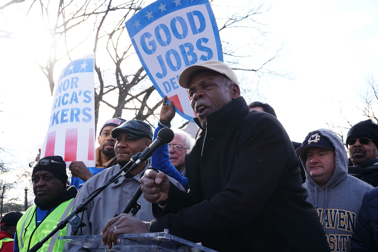 US actor Danny Glover speaks to labor activists as they demonstrate on February 16, 2017, after Andrew Puzder withdrew from his nomination as US Labor Secretary. Puzder withdrew on February 15 from consideration after facing intense scrutiny for his business record and controversies about his personal past. / AFP / MANDEL NGAN (Photo credit should read MANDEL NGAN/AFP/Getty Images)