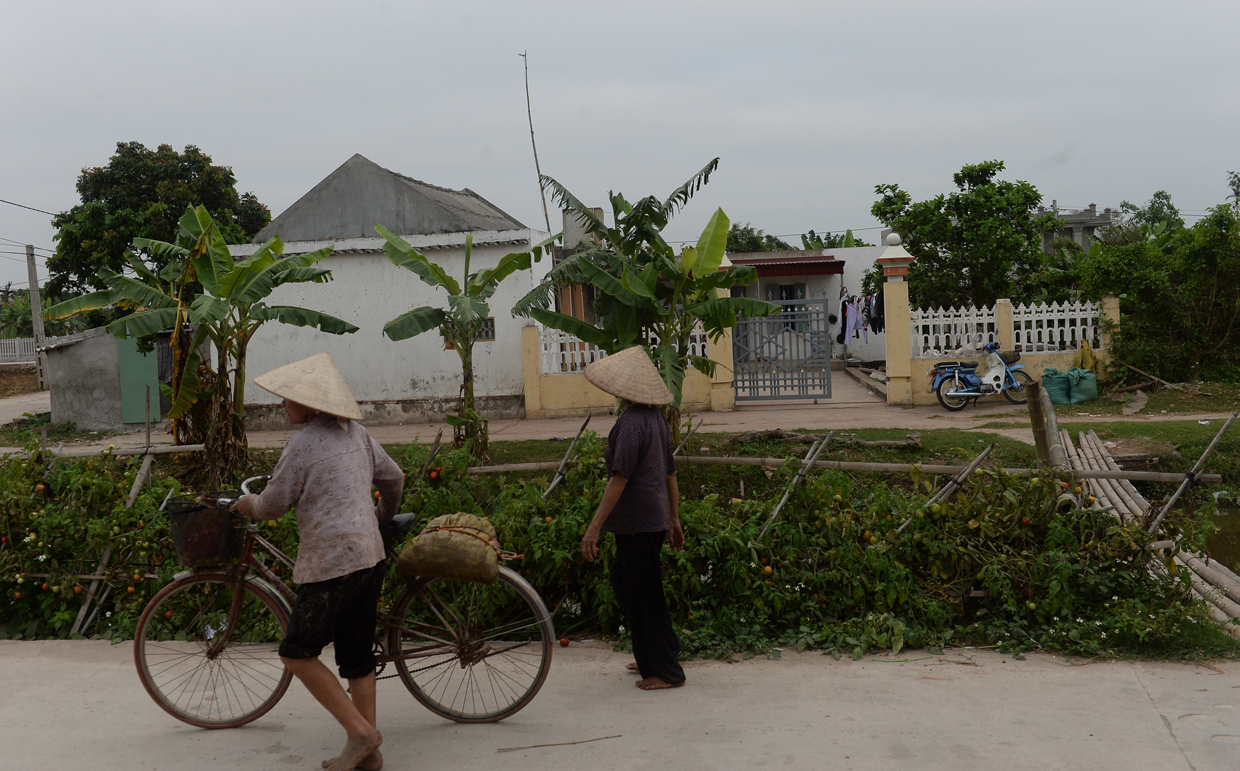 Villagers walk past the native home of Doan Thi Huong, a suspect involved in the assassination of Kim Jong-Un's half-brother, in Nghia Hung district, northern province of Nam Dinh on February 22, 2017. Detectives probing the assassination of Kim Jong-Un's half-brother want to question a North Korean diplomat, Malaysia's top policeman said. Royal Malaysian Police chief Khalid Abu Bakar said Vietnamese suspect Doan Thi Huong, 28, and Indonesian Siti Aishah, 25, had been trained to swab the man's face, practising in Kuala Lumpur before the assault at the airport. / AFP / HOANG DINH NAM (Photo credit should read HOANG DINH NAM/AFP/Getty Images)