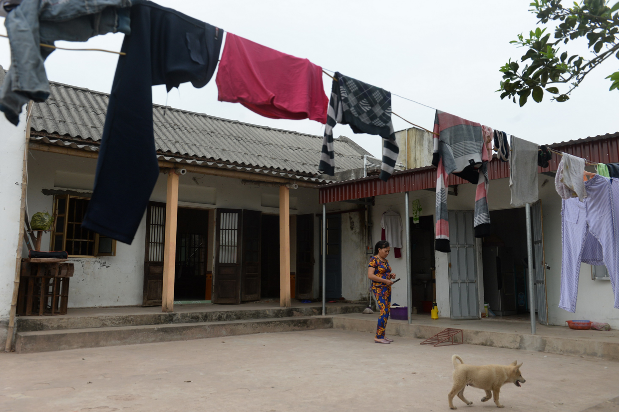 CORRECTION - Nguyen Thi Vy, 54, stepmother of Doan Thi Huong, a suspect involved in the assassination of Kim Jong-Un's half-brother, stands at Huong's family home in Nghia Hung district, northern province of Nam Dinh on February 22, 2017. Detectives probing the assassination of Kim Jong-Un's half-brother want to question a North Korean diplomat, Malaysia's top policeman said. Royal Malaysian Police chief Khalid Abu Bakar said Vietnamese suspect Doan Thi Huong, 28, and Indonesian Siti Aishah, 25, had been trained to swab the man's face, practising in Kuala Lumpur before the assault at the airport. / AFP / HOANG DINH NAM / The erroneous mention[s] appearing in the metadata of this photo by HOANG DINH NAM has been modified in AFP systems in the following manner: [stepmother ] instead of [mother in law]. Please immediately remove the erroneous mention[s] from all your online services and delete it (them) from your servers. If you have been authorized by AFP to distribute it (them) to third parties, please ensure that the same actions are carried out by them. Failure to promptly comply with these instructions will entail liability on your part for any continued or post notification usage. Therefore we thank you very much for all your attention and prompt action. We are sorry for the inconvenience this notification may cause and remain at your disposal for any further information you may require. / (Photo credit should read HOANG DINH NAM/AFP/Getty Images)