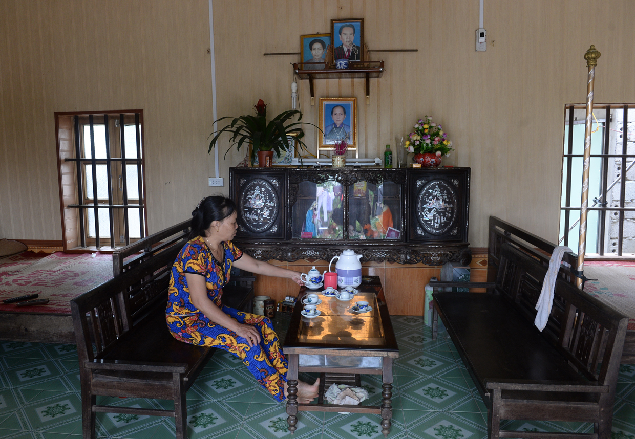 CORRECTION - Nguyen Thi Vy, 54, stepmother of Doan Thi Huong, a suspect involved in the assassination of Kim Jong-Un's half-brother, prepares tea for visitors inside Huong's family home with a family altar for ancestors in Nghia Hung district, northern province of Nam Dinh on February 22, 2017. Detectives probing the assassination of Kim Jong-Un's half-brother want to question a North Korean diplomat, Malaysia's top policeman said. Royal Malaysian Police chief Khalid Abu Bakar said Vietnamese suspect Doan Thi Huong, 28, and Indonesian Siti Aishah, 25, had been trained to swab the man's face, practising in Kuala Lumpur before the assault at the airport. / AFP / HOANG DINH NAM / The erroneous mention[s] appearing in the metadata of this photo by HOANG DINH NAM has been modified in AFP systems in the following manner: [stepmother ] instead of [mother in law]. Please immediately remove the erroneous mention[s] from all your online services and delete it (them) from your servers. If you have been authorized by AFP to distribute it (them) to third parties, please ensure that the same actions are carried out by them. Failure to promptly comply with these instructions will entail liability on your part for any continued or post notification usage. Therefore we thank you very much for all your attention and prompt action. We are sorry for the inconvenience this notification may cause and remain at your disposal for any further information you may require. / (Photo credit should read HOANG DINH NAM/AFP/Getty Images)