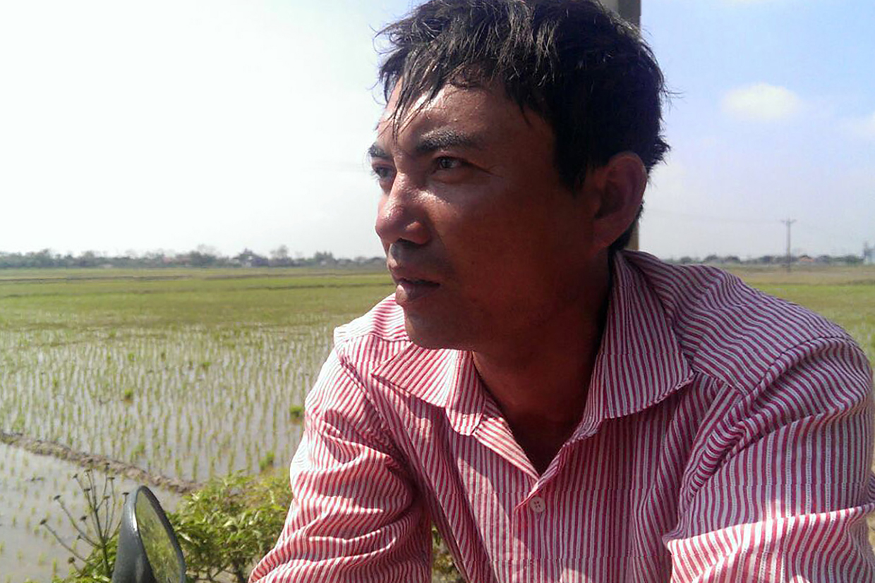 In this photo taken on February 19, 2017, Doan Van Binh, 41, elder brother of Doan Thi Huong, a Vietnamese woman accused of having taken part in the assasination of Kim Jong-Nam, half-brother of North Korea's leader Kim Jong-Un, speaks to reporters near his home in the northern Vietnamese village of Quan Phuong. The Vietnamese suspect in the killing of Kim Jong-Un's half-brother was renowned for her fashion, funky hairstyles and foreign boyfriends, say family members shocked at the link between their poor rice-farming village and a crime that has gripped the world. Doan Thi Huong gained notoriety last week after Malaysian police shared CCTV images of the 28-year-old at a Kuala Lumpur airport -- wearing a top emblazoned with "LOL" -- shortly after the February 13 assassination of Kim Jong-Nam. / AFP / STR (Photo credit should read STR/AFP/Getty Images)