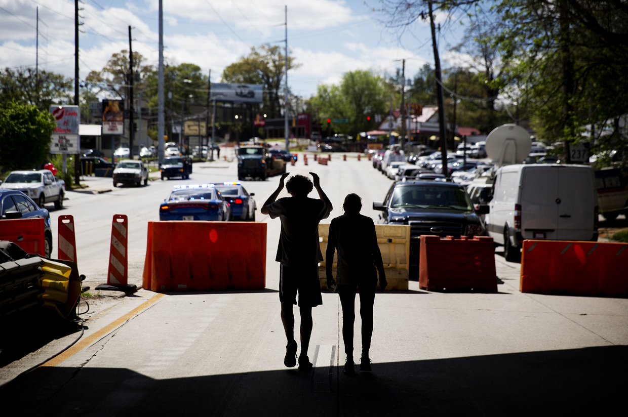 Pedestrians walk down a closed portion of Piedmont Avenue near an overpass that collapsed from a large fire on Interstate 85 in Atlanta, Friday, March 31, 2017. Atlanta's dreadful rush-hour traffic got even worse Friday, the morning after a raging fire underneath Interstate 85 collapsed an elevated portion of the highway and shut down the heavily traveled route through the heart of the city. (AP Photo/David Goldman)