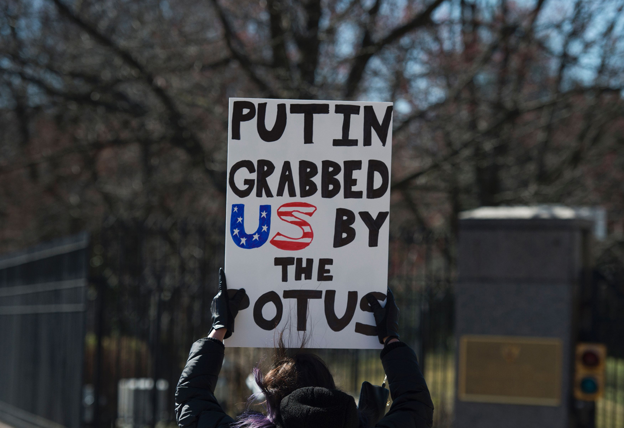 Protesters march against President Trump outside the Embassy of Russia on March 4, 2017, in Washington, DC. / AFP PHOTO / MOLLY RILEY (Photo credit should read MOLLY RILEY/AFP/Getty Images)