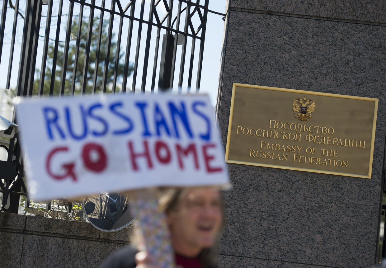 Protesters march against President Trump outside the Embassy of Russia on March 4, 2017, in Washington, DC. / AFP PHOTO / MOLLY RILEY (Photo credit should read MOLLY RILEY/AFP/Getty Images)