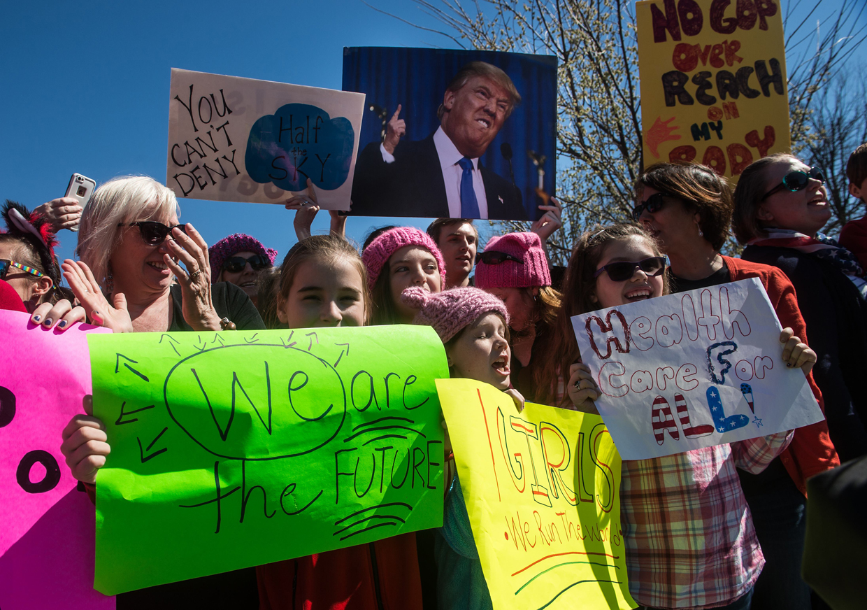 Supporters of women's rights gather after Democratic members of the US House of Representatives held a press conference to honor International Women's Day at the US Capitol in Washington, DC, on March 8, 2017. / AFP PHOTO / NICHOLAS KAMM (Photo credit should read NICHOLAS KAMM/AFP/Getty Images)