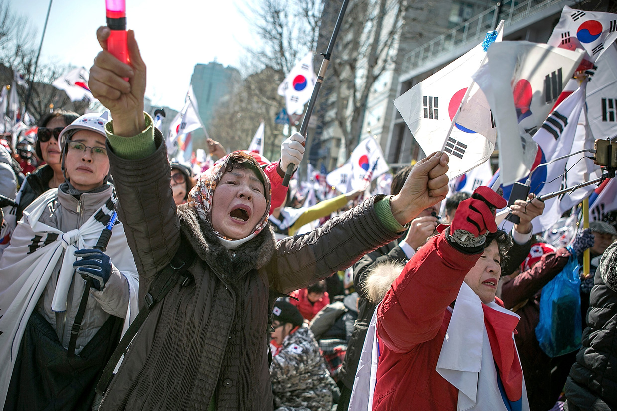 SEOUL, SOUTH KOREA - MARCH 10: Supporters of President Park Geun-hye react emotionally as the Constitutional Court had ruled the impeachment near the court on March 10, 2017 in Seoul, South Korea. Park will be permanently removed from the South Korean office and the nation will need to hold a presidential election within 60 days. Park had been impeached by parliament in December for allegedly letting her confidante Choi Soon-sil involved in state affairs and colluded to take bribes of millions of dollars from South Korean conglomerates. (Photo by Jean Chung/Getty Images)