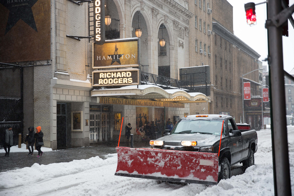 NEW YORK, NY - MARCH 14: A plow truck operates in front of the Richard Rodgers Theater, where "Hamilton" is performed, near Times Square during a day of heavy snow and freezing rain on March 14, 2017 in New York City. Many Broadway productions remained open despite the inclement weather. (Photo by Kevin Hagen/Getty Images)