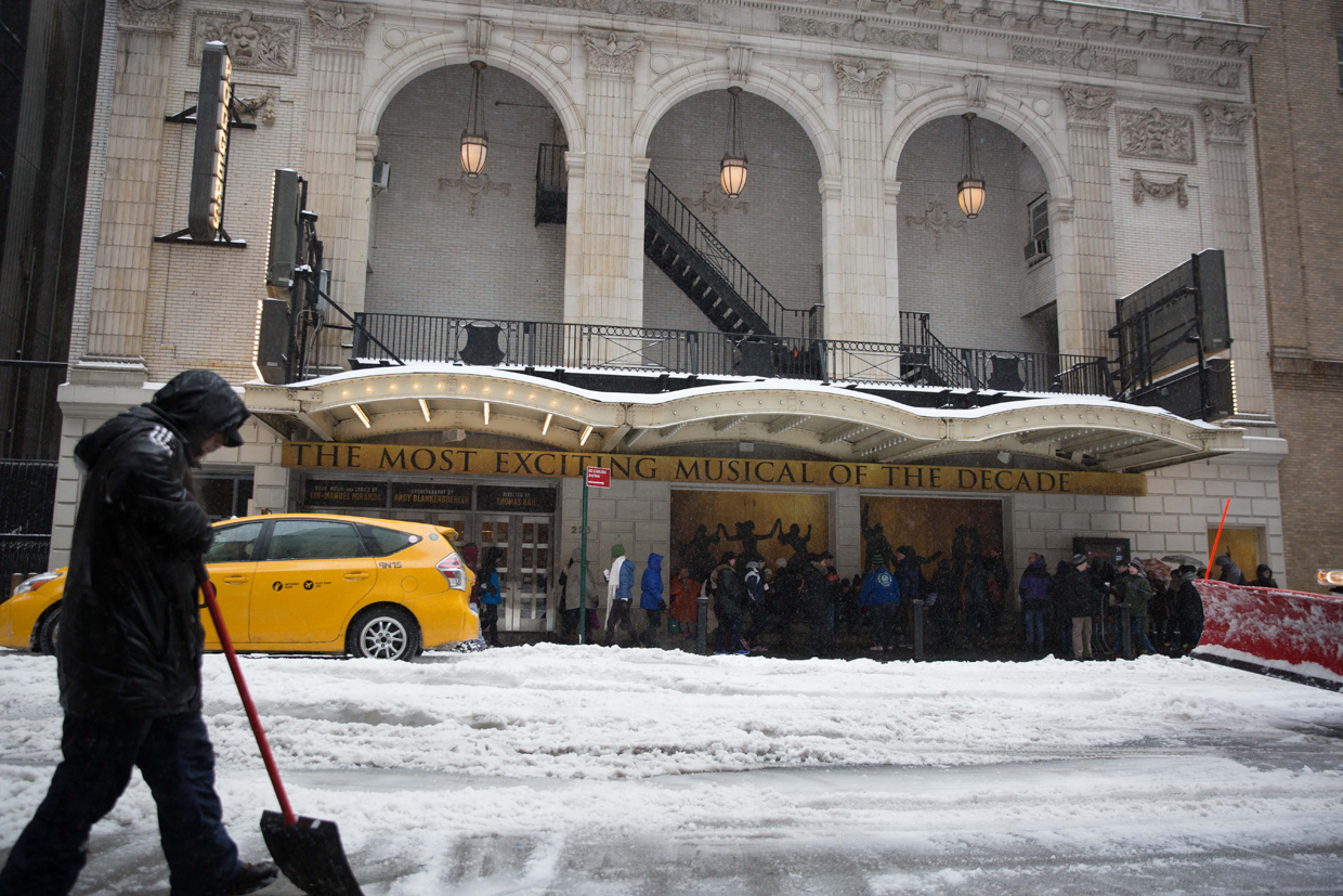 NEW YORK, NY - MARCH 14: A man shovels snow in front of the Richard Rodgers Theatre, where "Hamilton" is performed, near Times Square during a day of heavy snow and freezing rain on March 14, 2017 in New York City. Many Broadway productions remained open despite the inclement weather. (Photo by Kevin Hagen/Getty Images)