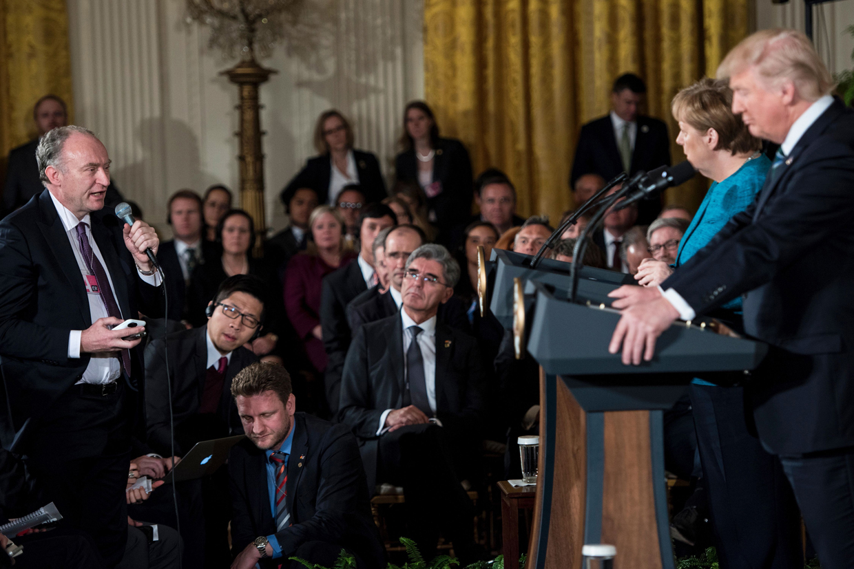 Germany's Chancellor Angela Merkel and US President Donald Trump listen to a question from German press during a press conference in the East Room of the White House on March 17, 2017 in Washington, DC. Trump said Friday he and Merkel agreed on the need for a "peaceful solution" to the conflict in Ukraine. / AFP PHOTO / Brendan Smialowski (Photo credit should read BRENDAN SMIALOWSKI/AFP/Getty Images)
