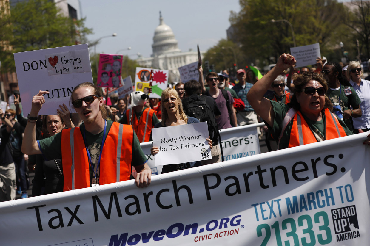 WASHINGTON, DC - APRIL 15: Tax Day demonstrators march away from the U.S. Capitol April 15, 2017 in Washington, DC. Activists gathered in cities nationwide to demand President Donald Trump release his tax returns. (Photo by Aaron P. Bernstein/Getty Images)