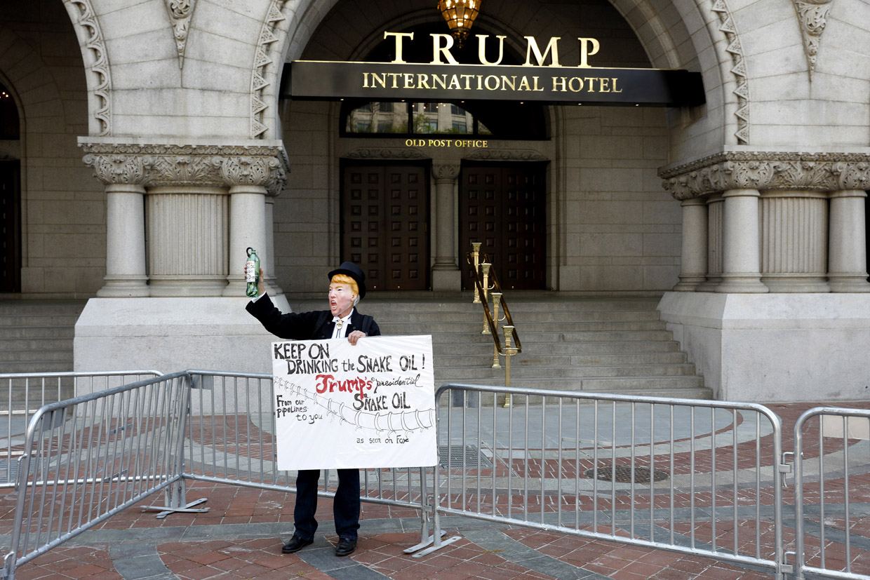 WASHINGTON, DC - APRIL 15: A protestor dressed as President Donald Trump stands outside the Trump International Hotel April 15, 2017 in Washington, DC. Activists gathered in cities nationwide to demand President Donald Trump release his tax returns. (Photo by Aaron P. Bernstein/Getty Images)