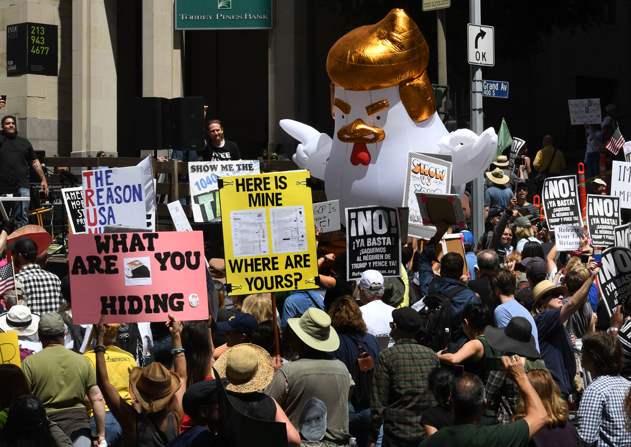 Protestors take part in the "Tax March" calling on US President Donald Trump to release his tax records in Los Angeles, California on April 15, 2017. / AFP PHOTO / Mark RALSTON (Photo credit should read MARK RALSTON/AFP/Getty Images)